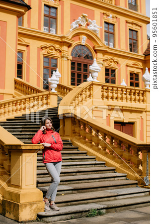 Beautiful Girl Posing Near Favorite Palace At Ludwigsburg, Germany. Favorite Castle Is The Oldest German Porcelain Castle Near The Village Of Forch Near Rastatt. Schloss Favorite, Baden-Wuerttemberg. 95601851