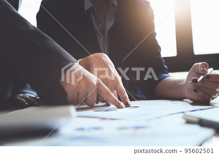 An auditor pointing to documents to examine budgets and financial fraud An auditor pointing to documents to examine budgets and financial fraud 95602501