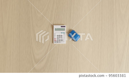 A photorealistic 3D illustration of a miniature car made of clay and a calculator placed on a flat surface using CG. A photorealistic 3D illustration of a miniature car made of clay and a calculator placed on a flat surface using CG. 95603381