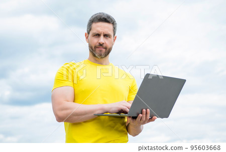 man check email on laptop on sky background 95603668