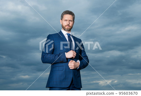Businessman sky background. Businessman in suit. Serious grizzled businessman outdoors Businessman sky background. Businessman in suit. Serious grizzled businessman outdoors 95603670
