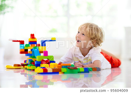 Child playing with toy blocks. Kids play. Child playing with toy blocks. Kids play. 95604009