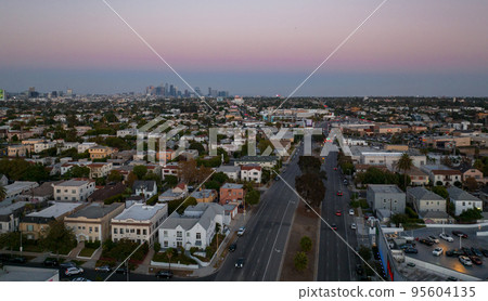 Los Angeles hot sunset view with palm tree and downtown in background. California, USA theme - background. Art photography Los Angeles hot sunset view with palm tree and downtown in background. California, USA theme - background. Art photography 95604135