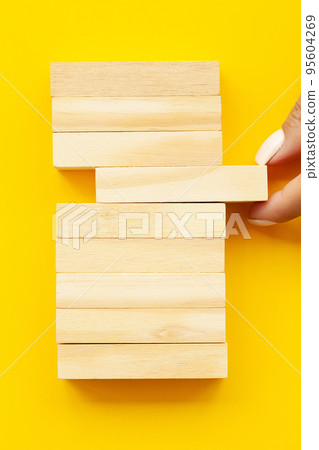 Woman hand stacked wooden blocks with space for text 95604269