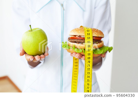 Choose between junk food versus healthy diet Choose between junk food versus healthy diet 95604330