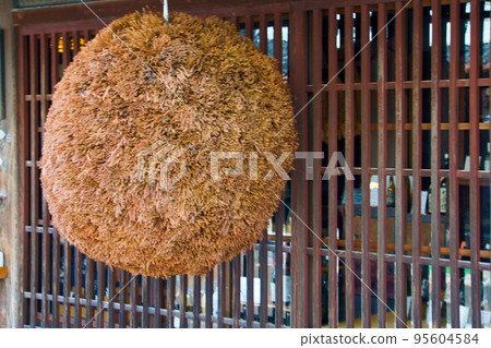 A large cedar ball in front of a sake brewery A large cedar ball in front of a sake brewery 95604584