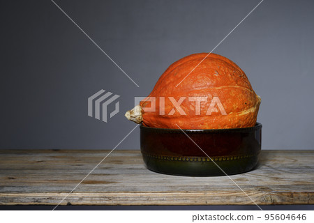 orange Hokkaido pumpkin in a ceramic bowl orange Hokkaido pumpkin in a ceramic bowl 95604646