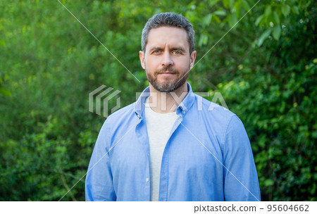 Portrait of handsome professional man in blue shirt natural background Portrait of handsome professional man in blue shirt natural background 95604662