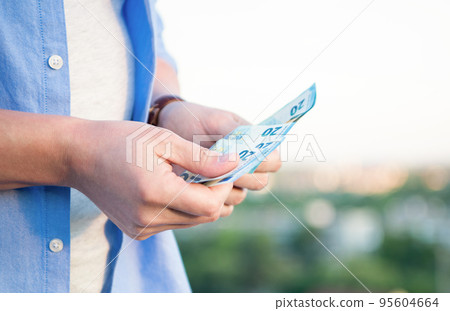 Guy crop view counting cash money banknotes blur outdoors Guy crop view counting cash money banknotes blur outdoors 95604664