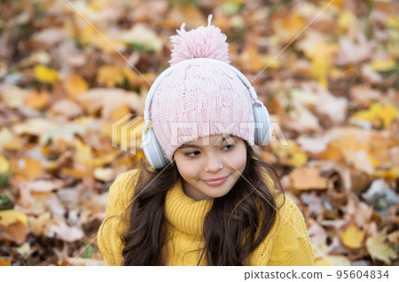 fall season fashion. portrait of teen girl in hat on autumn leaves background. fall season fashion. portrait of teen girl in hat on autumn leaves background. 95604834
