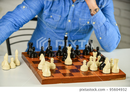 Intellectual hobby. Figures on wooden chess board. Thinking about next step. Development logics. Chess is life in miniature. Chess lesson. Strategy concept. School teacher. Board game. Playing chess Intellectual hobby. Figures on wooden chess board. Thinking about next step. Development logics. Chess is life in miniature. Chess lesson. Strategy concept. School teacher. Board game. Playing chess 95604932