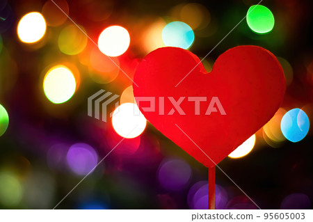 Red heart on backdrop of bright multi-colored lights. Red heart on backdrop of bright multi-colored lights. 95605003