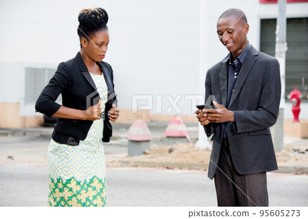businessman using a mobile phone in the street 95605273