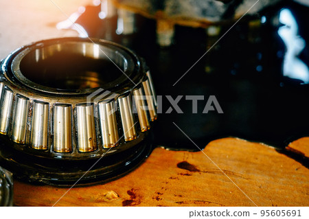 Lubricated roller bearing. Truck suspension repair part. Close-up. Background.. 95605691