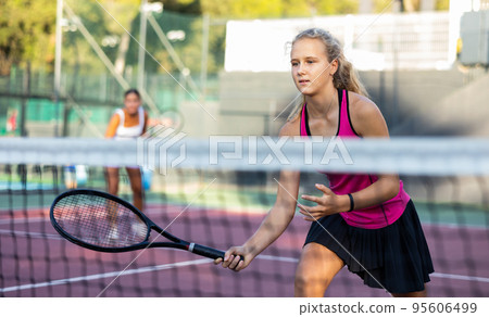 Woman tennis player training on court Woman tennis player training on court 95606499
