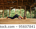 Woman Practicing Yoga in Tropical Open Yoga Studio place 95607841
