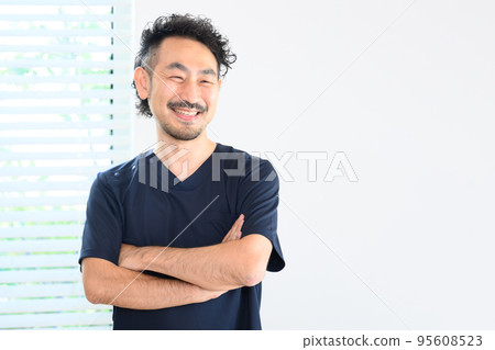 An image of a veteran doctor wearing a surgical gown with copy space 95608523