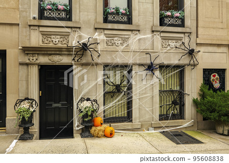 Front of apartment building decorated with spider web for Halloween holiday in Manhattan New York Front of apartment building decorated with spider web for Halloween holiday in Manhattan New York 95608838
