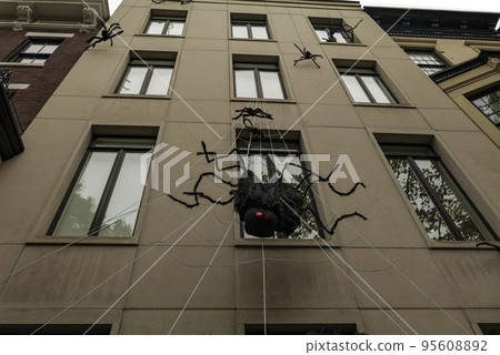 Front of apartment building decorated with spider web for Halloween holiday in Manhattan New York 95608892