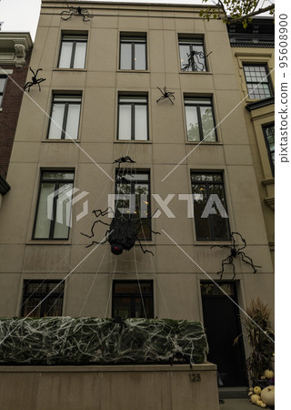 Front of apartment building decorated with spider web for Halloween holiday in Manhattan New York 95608900