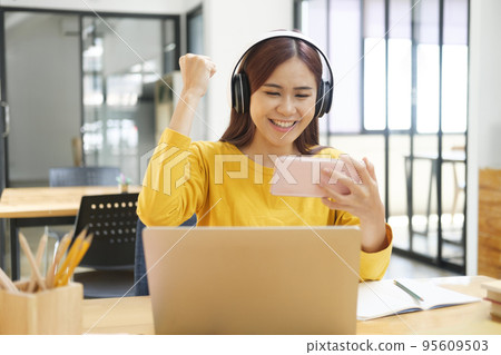 Young woman happy with her online study. Young woman happy with her online study. 95609503