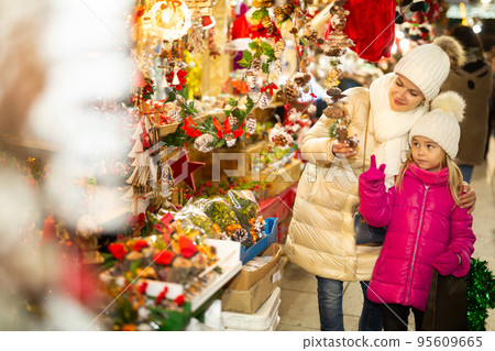 Smiling woman with small daughter in Christmas market 95609665