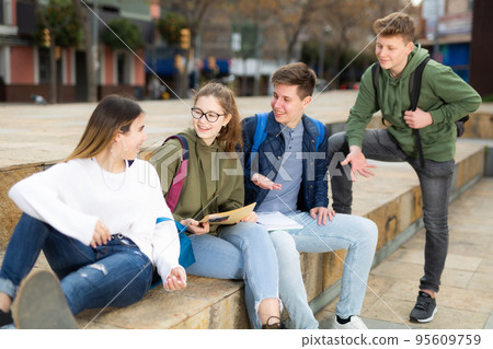 Group of positive teenagers having fun together 95609759