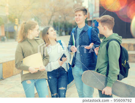 Guy and girl are walking carelessly down street 95609792