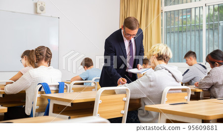 Teenage students working at class during lesson Teenage students working at class during lesson 95609881