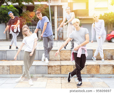 Group of teenagers performing street dance outdoors 95609897