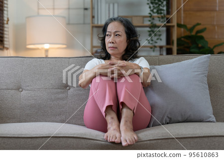 Depressed Elderly Asian woman sitting alone at home. Retired woman concept. 95610863
