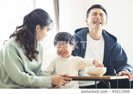 Smiling family sitting on the sofa 95611906
