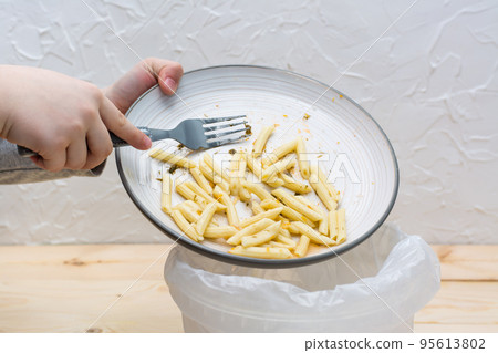 Stop wasting food. Leftover lunch is dumped in the bin. Food waste concept. Stop wasting food. Leftover lunch is dumped in the bin. Food waste concept. 95613802