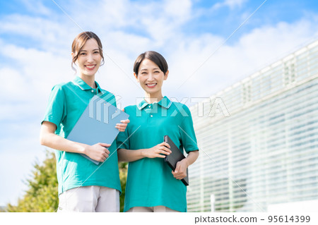 Smiling caregiver in her thirties Smiling caregiver in her thirties 95614399