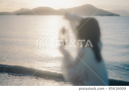 Photo of a woman standing by the beach Photo of a woman standing by the beach 95616009