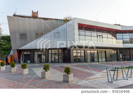 details of aluminum facade with colorful red and orange panels on large shopping mall details of aluminum facade with colorful red and orange panels on large shopping mall 95616406