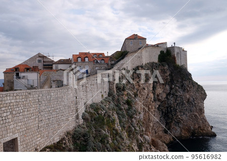 Defense walls of the old town of Dubrovnik, a well-preserved medieval fortress and a popular tourist destination, Croatia 95616982