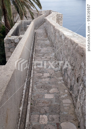 Defense walls of the old town of Dubrovnik, a well-preserved medieval fortress and a popular tourist destination, Croatia Defense walls of the old town of Dubrovnik, a well-preserved medieval fortress and a popular tourist destination, Croatia 95616987