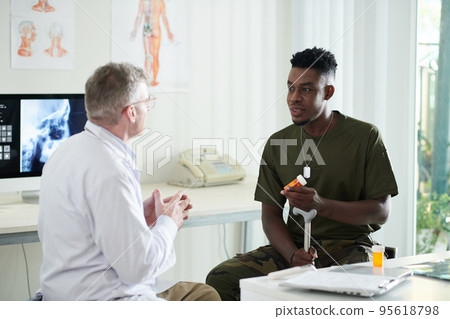 General practitioner and patient discussing results of taking new pills 95618798