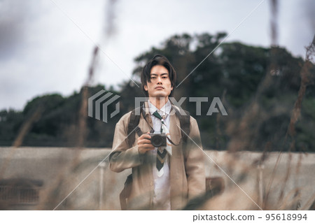 A man waiting for the camera in the meadow A man waiting for the camera in the meadow 95618994
