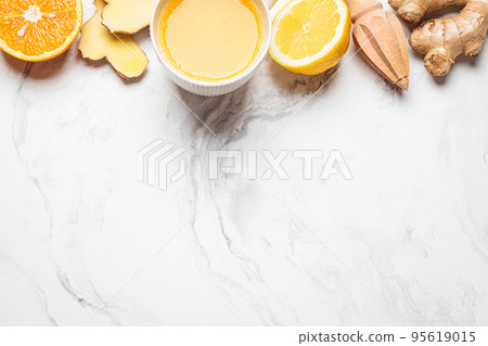 Ginger orange drink and ingredients background, copy space. Winter beverage for immunity boosting. 95619015