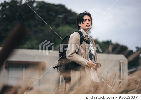 A man waiting for the camera in the meadow A man waiting for the camera in the meadow 95619037
