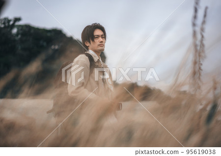 A man waiting for the camera in the meadow A man waiting for the camera in the meadow 95619038