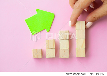 Woman hand arranging empty wood block and copy space on pink background Woman hand arranging empty wood block and copy space on pink background 95619497