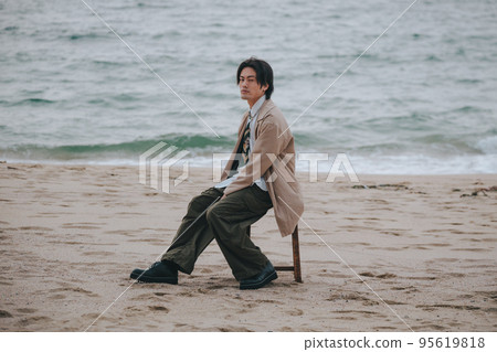 man sitting on a chair and posing man sitting on a chair and posing 95619818