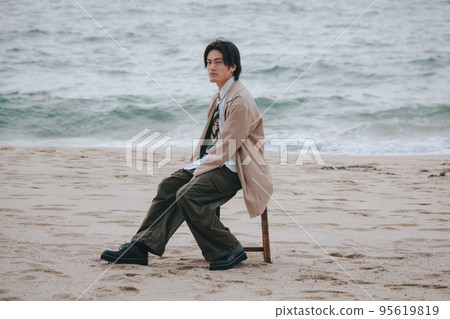 man sitting on a chair and posing man sitting on a chair and posing 95619819