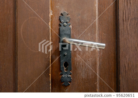 Old wooden door with metal handle. Old wooden door with metal handle. 95620651