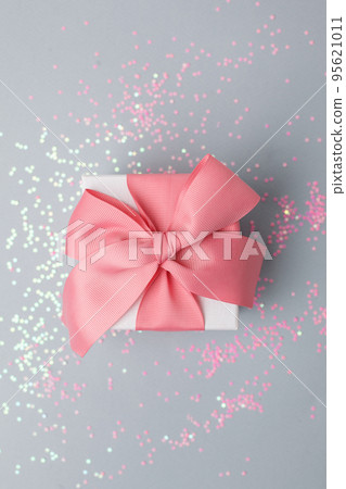 Gift or present box and stars confetti on gray table top view. Flat lay composition for birthday, mother day, christmas, new year, valentine or wedding. Stylish luxury monochrome concept, sale 95621011