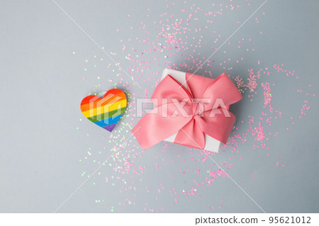 Stylish luxury gift box with rainbow LGBT heart on a light gray table. Homosexual and lgbt concept of holiday, birthday, valentine day, banner, flyer, innvitation Stylish luxury gift box with rainbow LGBT heart on a light gray table. Homosexual and lgbt concept of holiday, birthday, valentine day, banner, flyer, innvitation 95621012
