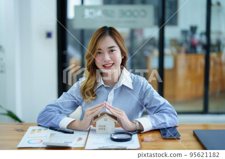portrait of an asian man, Agent, buy and sell land, property tax, show the concept of protecting the house to insure the risk of damage to the home. portrait of an asian man, Agent, buy and sell land, property tax, show the concept of protecting the house to insure the risk of damage to the home. 95621182